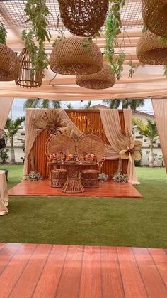 an outdoor wedding setup with white drapes and wicker decorations