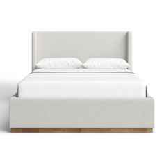 the bed is made up with white linens and wood frame, but no headboard or foot board