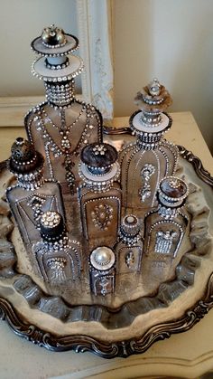 an ornate silver plate on a table in front of a mirror