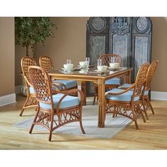 a dining room table with blue chairs around it