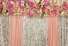 pink and silver sequin backdrop with flowers on the side for a wedding or event