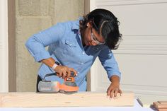 a woman is using a power drill to cut wood with a cordless jig