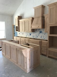 an unfinished kitchen with wooden cabinets and drawers