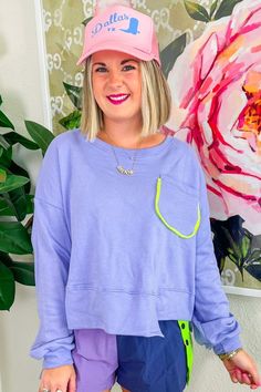 The Sweet Lines Top brings a burst of playful color to your casual days! With its bold purple hue, lime green-trimmed pocket, and asymmetric hem, this sweatshirt-style top is ready to be your go-to layer for a morning match on the tennis court or an afternoon coffee run. Style it over a tennis dress or pair it with your favorite athletic shorts for a look that's as fun and active as you are!PRODUCT FIT - TRUE TO SIZE MODEL DETAILS - BRENNA IS WEARING A SIZE SMALL, 5'3" CAROLINE IS WEARING A SIZE Purple Casual Sweatshirt With Pockets, Green Tops With Kangaroo Pocket For Spring, Spring Crew Neck Top With Kangaroo Pocket, Sporty Purple Sweatshirt For Spring, Crew Neck Top With Kangaroo Pocket For Spring, Green Crew Neck Top With Kangaroo Pocket, Sweet Lines, Afternoon Coffee, Coffee Run