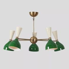 three green and white lights hanging from a brass ceiling fixture with two lamps on each side