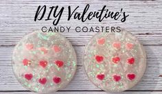 two heart shaped candy coasters sitting on top of a white wooden table with the words diy valentine's candy coasters