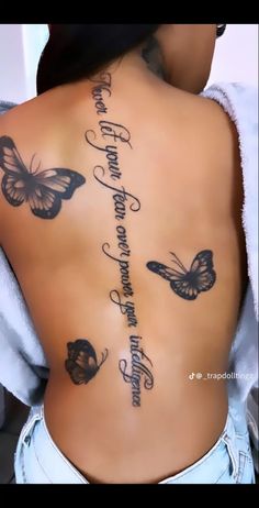 a woman's back with butterflies on it and the words written in cursive writing