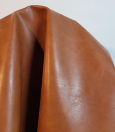 the back end of a brown leather chair