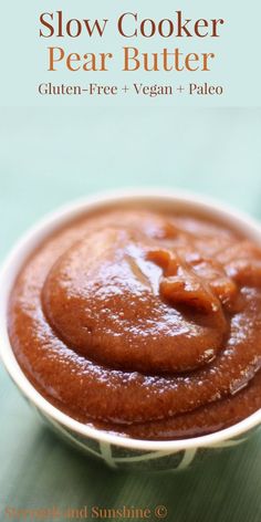 a bowl filled with peanut butter on top of a green tablecloth and text overlay reads slow cooker pear butter gluten - free + vegan + pale + pale