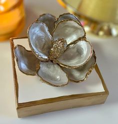 a white flower sitting on top of a wooden box