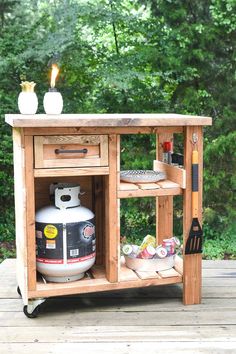 an outdoor kitchen island made out of pallet wood with a propane stove on top