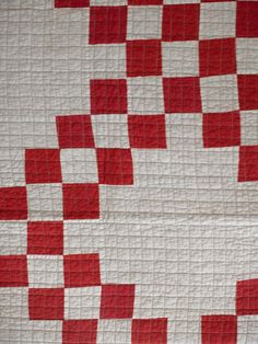 a red and white quilt with squares on it