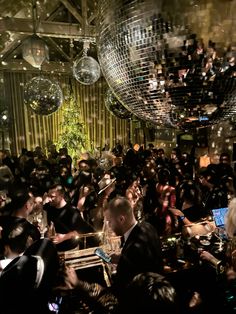 a large group of people in a room with disco balls