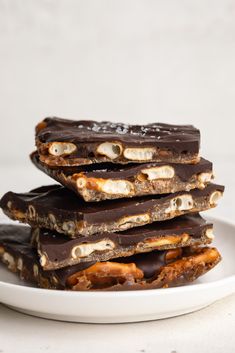 three pieces of chocolate and marshmallow barkle on a white plate