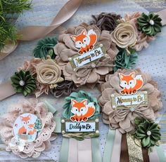 three baby hair clips with foxes on them and ribbons around the edges, sitting next to each other