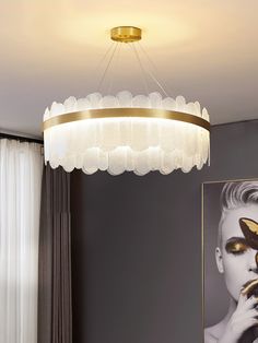 a chandelier hanging from the ceiling in a living room