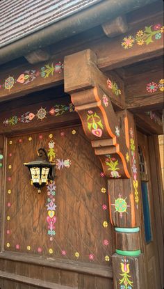 a wooden building with flowers painted on it