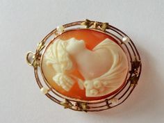 "Beautiful large antique hand carved cameo bezel set in 10k yellow gold and surrounded with fine gold leaves and seed pearls. In fine jewelry, cameo is an object carved in relief from a high-quality material such as stone, shell or coral. Antique cameos were carved by hand, often from a likeness or photograph of the subject. A combination of artistic ability, skill and years of experience were needed to create lifelike portraits. Napoleon's Empress Josephine wore a shell cameo daily, making them Heirloom Cameo Brooch For Wedding, Heirloom Cameo Wedding Brooch, Heirloom Cameo Brooches For Weddings, Art Nouveau Cabochon Wedding Brooches, Art Nouveau Cabochon Brooches For Weddings, Victorian Style Cameo Brooch For Weddings, Victorian Cameo Brooch For Wedding, Antique Cameo Brooches For Wedding, Gold Cameo Jewelry In Art Nouveau Style