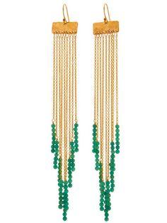 the gold and green beaded earrings are hanging from long chains with beads on them