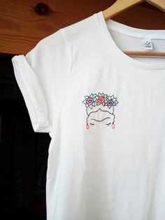 a white t - shirt with flowers on it