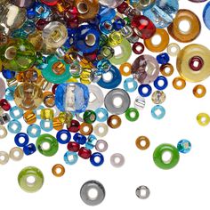 many different colored glass beads are scattered on the floor, including one with a hole in the middle