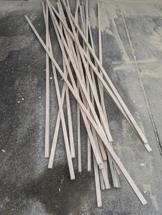 several wooden sticks laying on the ground next to each other