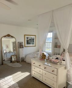 a bedroom with a bed, dresser and mirror in it's centerpieces