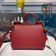 SHOP MORE LUXURY PRODUCTS HERE Description Dolce and Gabbana Small Sicily Bag In Dauphine Red For Women 7.5in/19cm DG Size: 13 x 19 x 6 cm / 5.1 x 7.5 x 2.4 inches (Length x Width x Height) Front flap with hidden magnetic fasteningBranded tag featuring two metal plating finishesTop handle and adjustable, detachable strap in DauphinePrinted fabric lining and flat pocketItem comes with a branded dust bag Includes box, dust bag.This product is of the premium quality. High-end Red Shopping Bag, High-end Red Shoulder Bag, High-end Red Bag With Detachable Handle, High-end Red Crossbody Bag, High-end Red Bag With Removable Pouch, Designer Burgundy Bag With Handles, High-end Red Shoulder Bag With Double Handle, High-end Red Crossbody Shoulder Bag, High-end Red Shoulder Bag With Detachable Handle