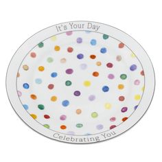 a white plate with multicolored dots on it that says, it's your day celebrating you