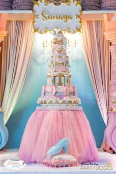 a pink and blue cake on display in front of a backdrop that says, sunnya