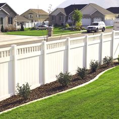 a white fence in front of some houses