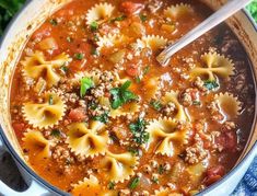 a pot filled with pasta and meat soup