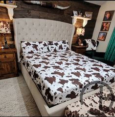 a bed with brown and white cow print on it