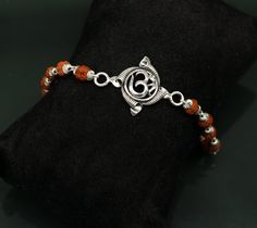 925 sterling silver handmade custom Aum design Bracelet Or Rakhi bracelet with rudraksha chain, this is special design Rudraksha Rakhi for Rakshabandhan Festival in India, best wishes gift for your brother and sister's , Metal-925 sterling silver.Item type-Rakhi Bracelet.Length-7.5 inches.(length will be customized if buyer request)Weight-6.120 grams.Center piece size-2.3 cm diameter.Rudraksha size-6 mm approx.Stamped-925.Make excellent gifting and collectible pieces(gift for birthday, wedding, Rudraksha Rakhi, Rakhi Bracelet, Rakhi Design, Design Bracelet, Precious Jewels, Unisex Jewelry, Best Wishes, Silver Pendants, Bracelet Length