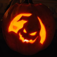 a carved pumpkin with an evil face on it