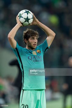 a man holding a soccer ball on top of his head