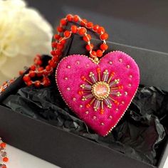 This bright pink heart pendant necklace will  definitely add a charm to any outfit or can be a perfect gift for any occasion.  Long orange glass beads necklace is crocheted by hand  with orange glass beads and embellished with hot pink velvet heart pendant. The pendant is embroidered with glass beads and the sparkle crystal in the center. This unique handmade piece of jewelry could be a perfect gift for whose who loves handcrafted artsy jewelry.  💝Jewelry comes in a lovely box and is ready for Heart-shaped Beaded Necklace For Parties, Handmade Orange Necklaces For Party, Heart Pendant Beaded Necklace For Parties, Handmade Orange Beaded Pendant Necklace, Handmade Pink Necklace As Gift, Party Beaded Necklaces With Heart Pendant, Heart Charm Beaded Necklace For Gift, Pink Heart Beads Pendant Necklace, Party Heart-shaped Beaded Necklaces With Heart Beads