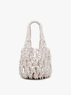 a white handbag is shown on a white background and it looks like an intricate woven bag