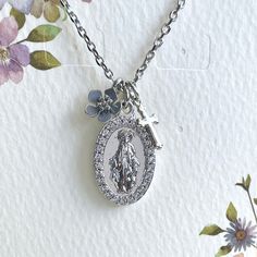 This dainty Our Lady of Guadalupe, St. Mary necklace is made of the following: Medal Pendant: silver plated over brass with cubic zirconia (size: 21 x 13mm) Cross Pendant: silver plated over brass  Large: 19 x 10mm Small: 12 x 7 mm Necklace Chain: silver plated over brass  ✏️ Please choose and the length of the chain (the length includes lobster clasp and findings) 【IMPORTANT INFORMATION BEFORE PURCHASE】 🔘 TAXES: VAT, GST, and any other taxes are not included in the listing price and are the buyer's responsibility upon delivery. 🔘 CUSTOMS: Buyers are responsible for any customs and import taxes that may apply. I am not responsible for delays due to customs. 🔘 COLOR VARIATION: Please note that colors may appear differently on various screens and under different lighting conditions. 🔘 PO Silver Necklace With Miraculous Medal For Wedding, Silver Our Lady Of Guadalupe Jewelry For Wedding, Silver Miraculous Medal Jewelry For Wedding, Silver Miraculous Medal For Wedding, Ring Charm Necklace, Mary Necklace, Virgin Mary Necklace, Our Lady Of Guadalupe, Lady Of Guadalupe