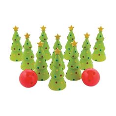 a group of plastic christmas trees with stars and balls in front of eachother