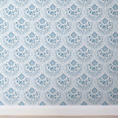 an empty room with blue wallpaper and wooden floor