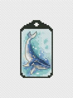 a cross stitch pattern with a whale in the ocean on it's back side