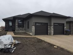 a house that is under construction in the middle of some dirt and rocks on the ground