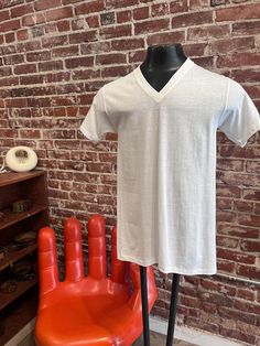 "Mens '70s Plain White V Neck Tee Shirt Beautiful men's seventies white v neck t-shirt. Super soft with the look and feel of cotton. The fabric is 50% combed cotton and 50% polyester. In perfect condition.  By Jockey Suprel 16.25\" shoulder  36\" chest  17.5\" pit to pit  29.75\" length from high point of shoulder to hem 7\" sleeve  No returns or exchanges.  Feel free to message us with any questions. We are happy to help and quick to respond. 🍏 Stay in touch @look.vintage: Instagram" Vintage Cotton V-neck Top, Vintage White V-neck Top, White Cotton V-neck T-shirt, Retro Cotton V-neck Tops, Vintage Cotton V-neck T-shirt, White Tee Men, Vintage Instagram, Blank White, Plain White