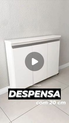 a white cabinet sitting on top of a tile floor next to a wall with the words despensa