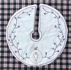 a piece of cloth that has been embroidered onto the side of a circle with a bird on it