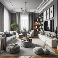 a living room filled with furniture and a large tv on top of a wooden floor