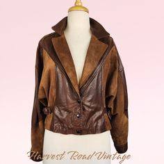 Embrace nostalgic 90s style with this stunning vintage crop jacket! Crafted with a mix of luxe suede and leather materials in a rich brown hue, this jacket exudes timeless elegance. The oversized silhouette in a Size 12 offers a comfy and on-trend look, perfect for the winter season. Channel your inner fashionista with this Women's Winter Classic piece that will elevate any outfit with its vintage charm. This jacket has been professionally DRY CLEANED since acquired by Harvest Road Vintage and h Brown Leather Jacket With Suede Overlays, Brown Leather Long Sleeve Cropped Jacket, Brown Leather Cropped Jacket With Long Sleeves, Vintage Brown Leather Jacket For Fall, Retro Brown Leather Jacket For Fall, Spring Brown Leather Jacket With Suede Overlays, Vintage Fitted Suede Leather Jacket, Vintage Brown Suede Leather Jacket, Nostalgic 90s