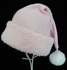 "Soft baby pink fleece is accented with a matching pink sherpa faux fur trim in thi9s novel rendition of the traditional Santa stocking hat.  The fleece is a quality fabric, cozy and warm, and there is a turn up pink fur brim and faux fur white pompom dangle on the tip. The head measurement is 24-25\" circumference for the opening and the length of the hat is 19\".  Check to make sure this measurement works for you.  Customization may be available depending on material availability at the time o Pink Christmas Party, Pink Santa Hat, Santa Claus Costume, Pink Sherpa, Holiday Hats, Stocking Hat, Santa Stocking, Pink Holiday, Pink Fleece