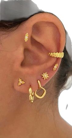 a woman's ear with five different types of piercings